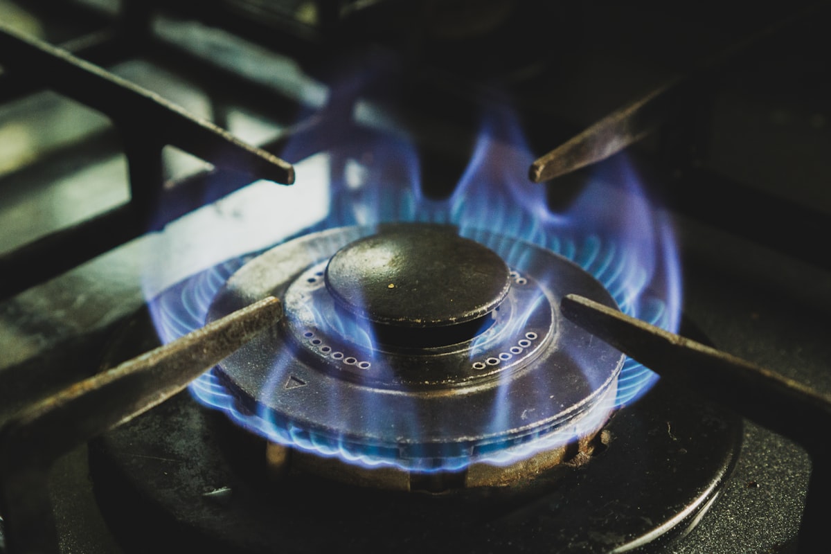 A gas hob burning with healthy blue flames, the annual landlord gas safety check confirms appliances burn safely